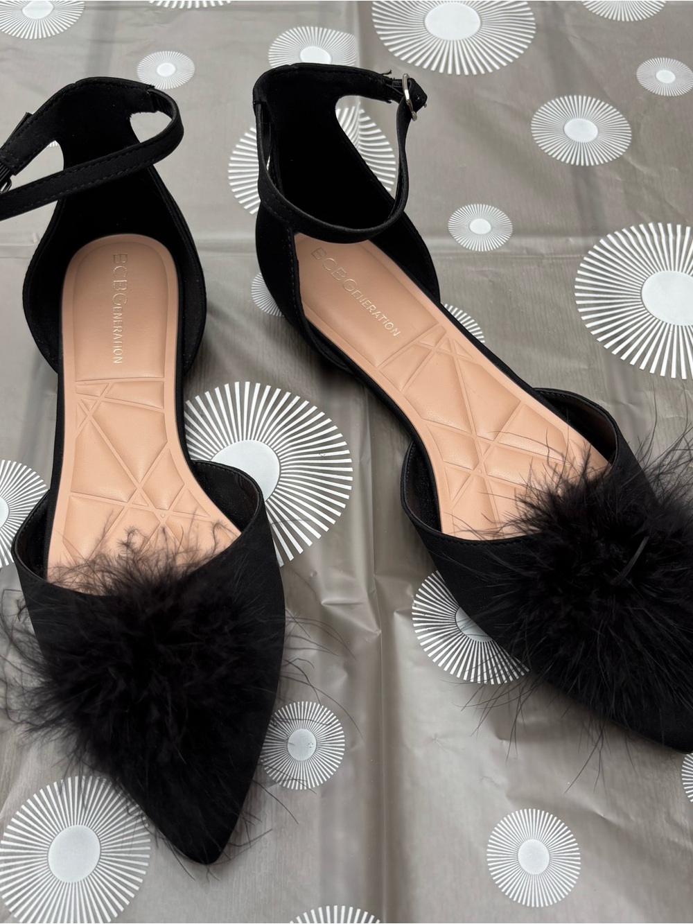 BCBGeneration Black Pointed Ankle-Strap Flats with Feather Pom